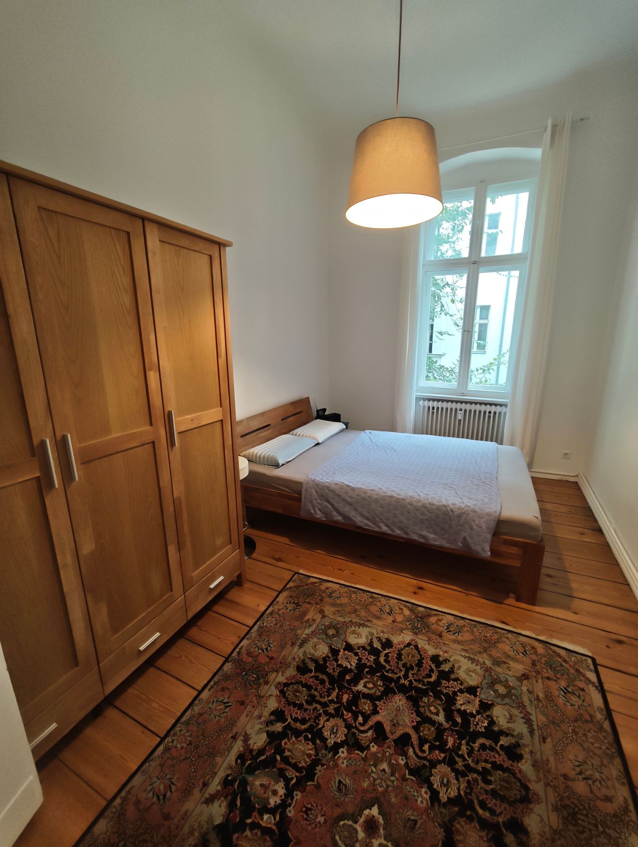 Stylish classic 2-room flat with wooden floors, chandelier & balcony