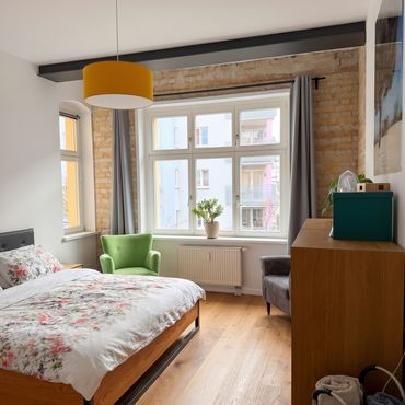 Bright period apartment with bay window, balcony and brick walls in Helmholtz Kiez in Prenzlauer Berg
